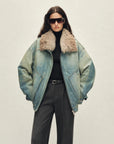 Model wearing Firelady Fur Warm Mist Glass women's Blue denim parka with SAGAFURS fox fur collar front view