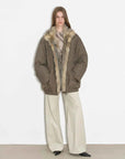 Model wearing Fireladyfur Travel Notes sand green warm winter down jacket with fluffy fox fur collar