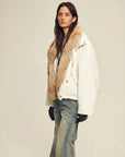 Side view of Firelady Fur Epoch Winter white fur collar parka styled with denim