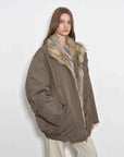 Side view of model wearing Fireladyfur Travel Notes sand green down jacket with fluffy fox fur collar