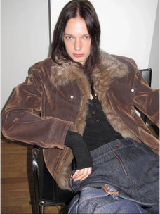 Seated close-up of Firelady Fur Wander Free chestnut brown denim parka with detachable fur collar