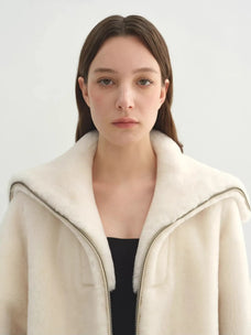 Model wearing the Butter Crisp pearl white Merino shearling leather coat, close collar view