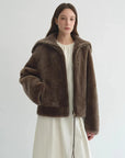 Model wearing the Butter Crisp smoked oak Merino shearling leather coat, front view