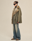 Model wearing Firelady Wilderness Parka green coat with two-tone Toscana coyote fur collar and jeans