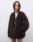 Model wearing the Castle Dusk camel brown V-neck Toscana shearling coat, close front view