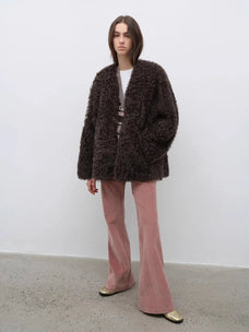 Model wearing the Castle Dusk camel brown V-neck Toscana shearling coat, full-length view