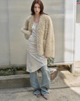 Model styling the Castle Dusk natural ivory V-neck Toscana shearling coat, full-length view