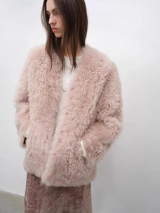 Model styling the Castle Dusk pink V-neck Toscana shearling coat, close lifestyle view