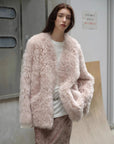 Model styling the Castle Dusk pink V-neck Toscana shearling coat outdoors