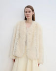 Model wearing Champagne Light Yellow fox fur jacket with hand in pocket