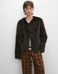 Woman wearing the Darcy Manor ink gray Toscana shearling coat, front view