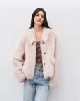 Woman wearing the Dream Walk dirty pink Toscana shearling coat, front view