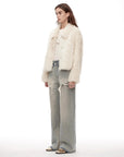Woman modeling the Dream Walk milky white shearling coat, side view