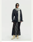 Woman wearing a grey Firelady Fur shimmer Merino wool and cashmere fringe scarf