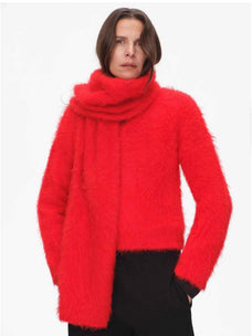 Woman styling a red alpaca wool scarf with a matching sweater