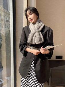 Woman wearing a silver gray mink flower scarf with a black blazer