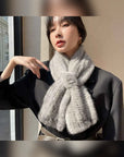 Woman wearing a silver gray mink flower scarf with tailored outfit