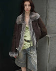 Woman styling the Florence dark brown shearling coat outdoors, close view