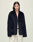 Woman wearing the Freezing Point Rum black Toscana shearling V-neck coat