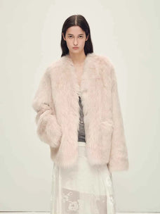 Woman wearing the Freezing Point Rum dirty pink Toscana shearling V-neck coat