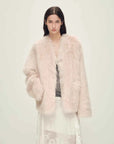 Woman wearing the Freezing Point Rum dirty pink Toscana shearling V-neck coat