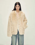 Woman wearing the Freezing Point Rum flax rice Toscana shearling V-neck coat