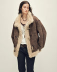 Model wearing the Galaxy Gala fog brown Merino shearling coat, close view