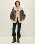 Model wearing the Galaxy Gala fog brown Merino shearling coat, full-length view