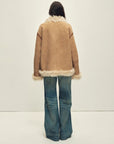 Model wearing the Galaxy Gala tortoiseshell yellow Merino shearling coat, back view
