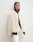Off-white Merino curly shearling coat, angled three-quarter view