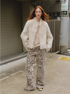 Woman styling the Healing Eros white Toscana shearling coat outdoors