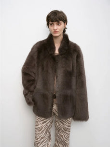 Woman wearing the Heartbeat Mark dark brown Toscana shearling coat, front view