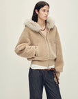 Model wearing Hokkaido Melody camel short hooded Merino shearling jacket, front view