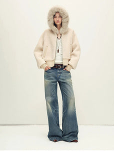 Model wearing Hokkaido Melody off-white short hooded Merino shearling jacket, full-length view