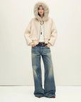 Model wearing Hokkaido Melody off-white short hooded Merino shearling jacket, full-length view