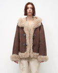 Model wearing the fog brown hooded Merino shearling jacket, view 1