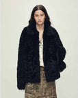 Woman wearing the Icelandic Bell Sound black Toscana curly coat, front view
