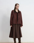 Reddish brown Merino shearling coat with high fur collar on model