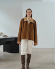 Yellowish brown Merino shearling coat with high fur collar on model