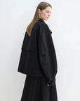 Side view of black Letrans Silent Trace parka with relaxed raglan sleeve