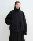 Black Letrans Silent Trace parka worn with stand collar and no fur collar