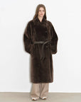 Model wearing the Mocha Phantom copper brown Merino shearling coat