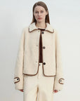 Woman wearing the off-white Modern Milk Cafe Merino shearling jacket, front view