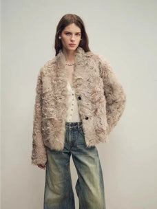 Model wearing the Mole Manor light champagne lake lamb shearling coat, close front view