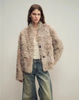 Model wearing the Mole Manor light champagne lake lamb shearling coat, close front view