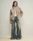 Model wearing the Mole Manor light champagne lake lamb shearling coat, full-length view