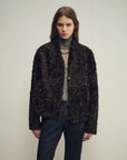 Model wearing the Mole Manor purple plum lake lamb shearling coat, close front view