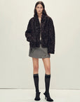 Model wearing the Mole Manor purple plum lake lamb shearling coat, full-length view
