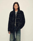 Woman wearing the Moro Garden black water ripple sheepskin coat, front view
