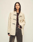 Woman wearing the Moro Garden coconut milk ash sheepskin coat, front view